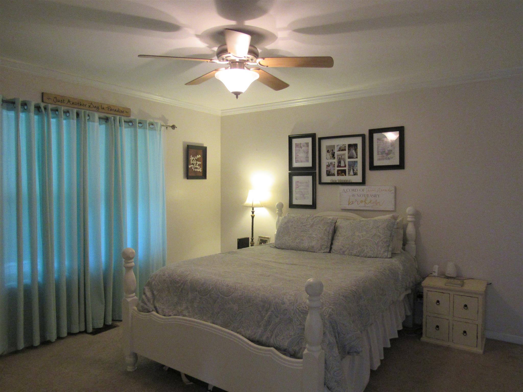 610 Cook Road Portland, TN 37148 - Photo 8 of 18 a bedroom with a large bed and a chandelier