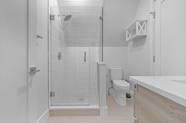 a bathroom with a shower and toilet