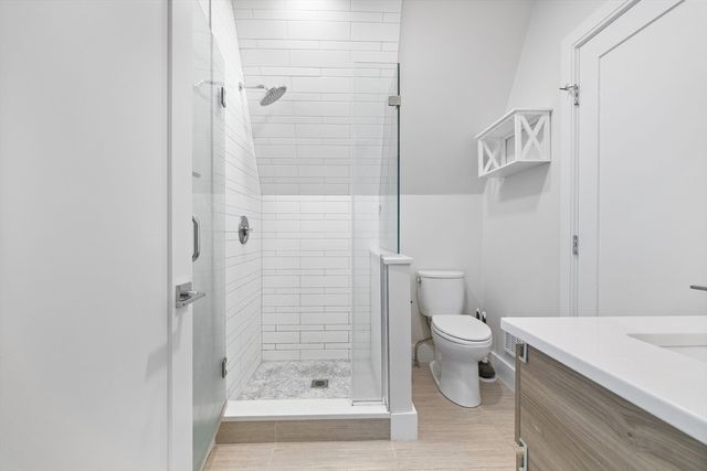 a bathroom with a shower and a toilet