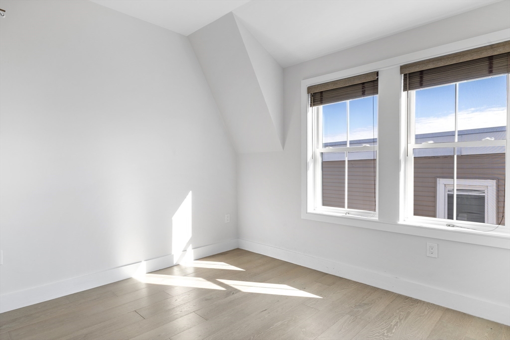 24 Rush Street, Unit G Somerville, MA 02145 - Photo 16 of 22 an empty room with windows
