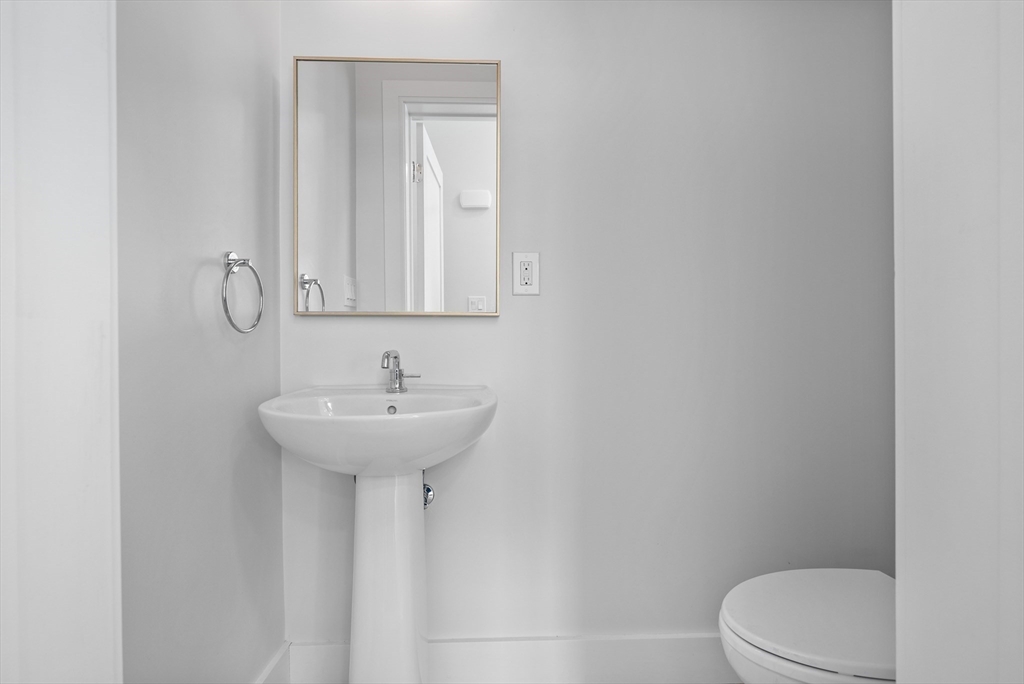 24 Rush Street, Unit G Somerville, MA 02145 - Photo 6 of 22 a bathroom with a sink a toilet and mirror
