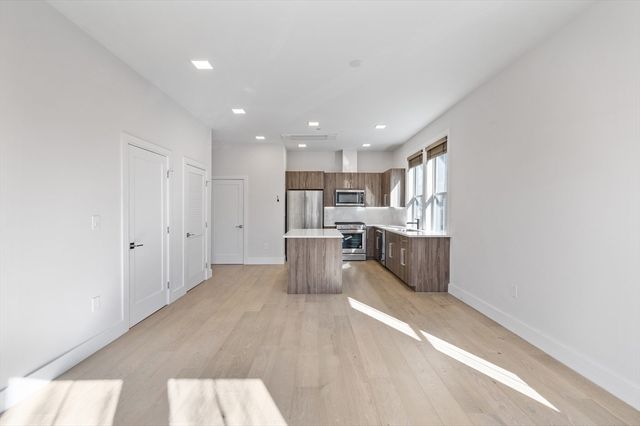 a kitchen with stainless steel appliances a refrigerator and a stove top oven