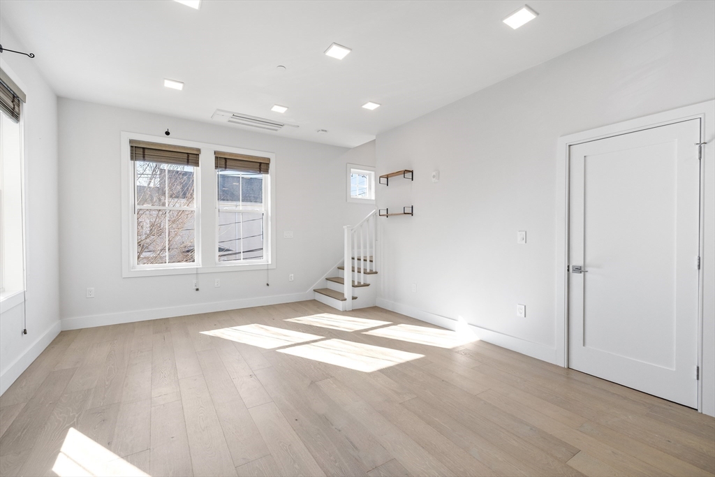 24 Rush Street, Unit G Somerville, MA 02145 - Photo 8 of 22 wooden floor in an empty room with a window