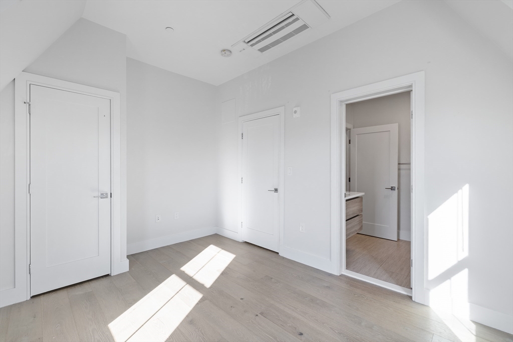 24 Rush Street, Unit G Somerville, MA 02145 - Photo 10 of 22 a view of empty room with wooden floor