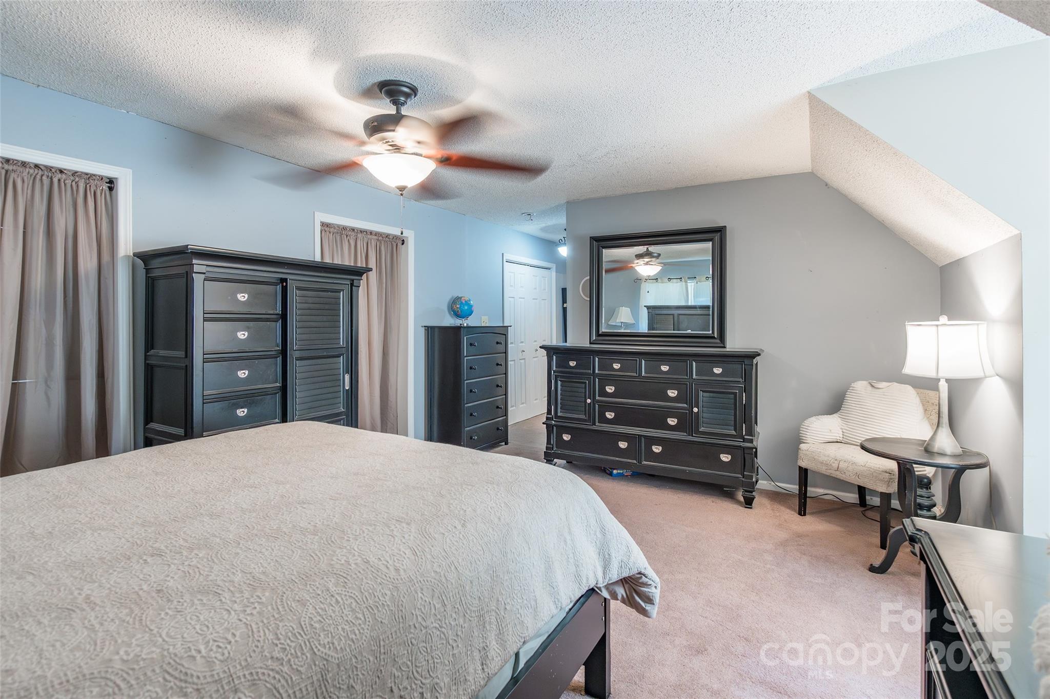 880 Columbia Road Chester, SC 29706 - Photo 25 of 40 a bedroom with a bed a dresser and a chandelier