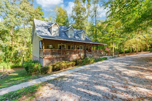 a view of a street sign under a large tree