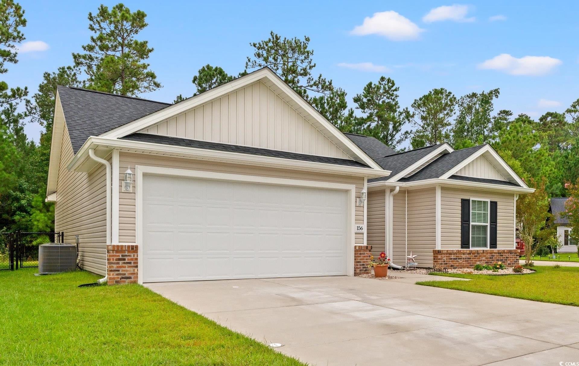 156 Hamilton Way Conway, SC 29526 - Photo 1 of 36 View of front of home featuring a front lawn, board and batten siding, roof with shingles, driveway, and an attached garage