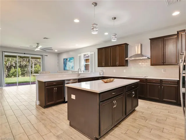 a kitchen with a stove sink and cabinets