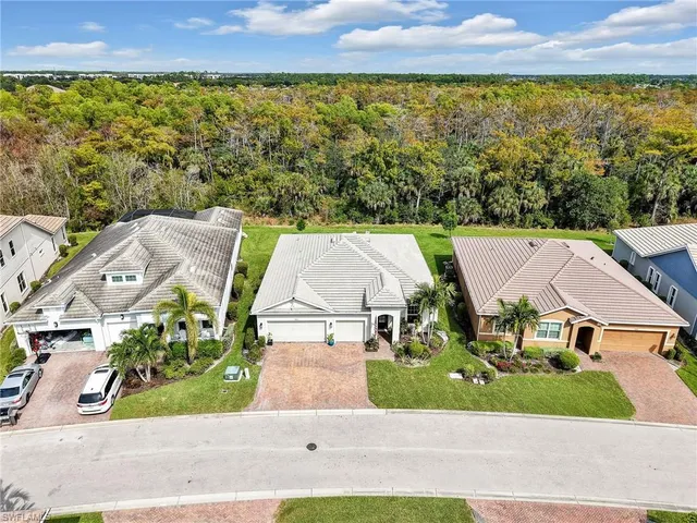 an aerial view of residential houses with outdoor space and street view