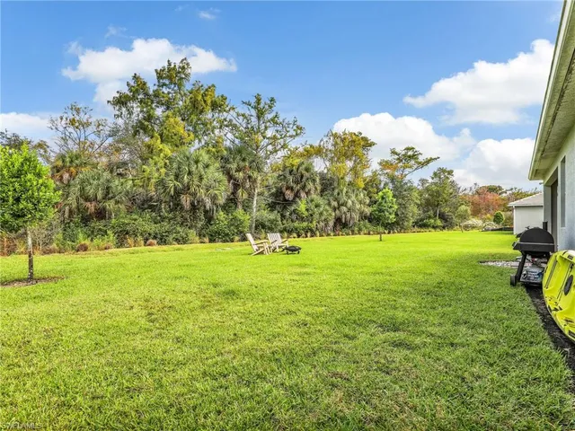 a view of a porch with chairs and potted plants