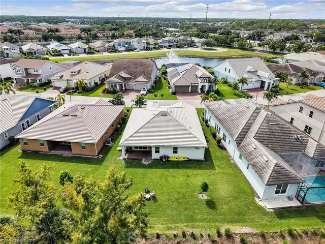 an aerial view of a house with swimming pool and ocean view