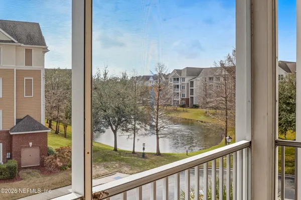 a view of a balcony with a yard