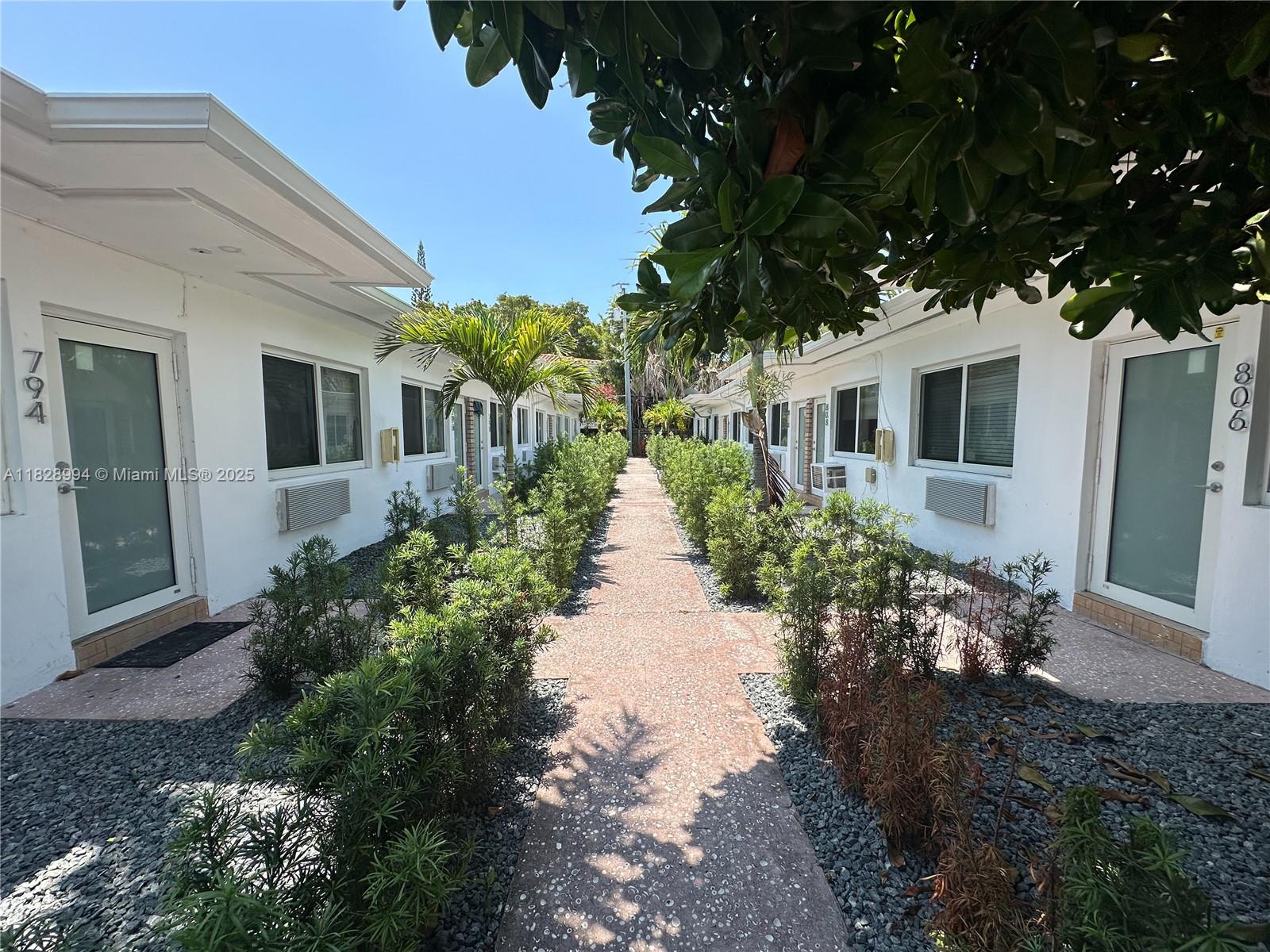 800 85th Street, Unit 794 Miami Beach, FL 33141 - Photo 7 of 13 a front view of a house with garden