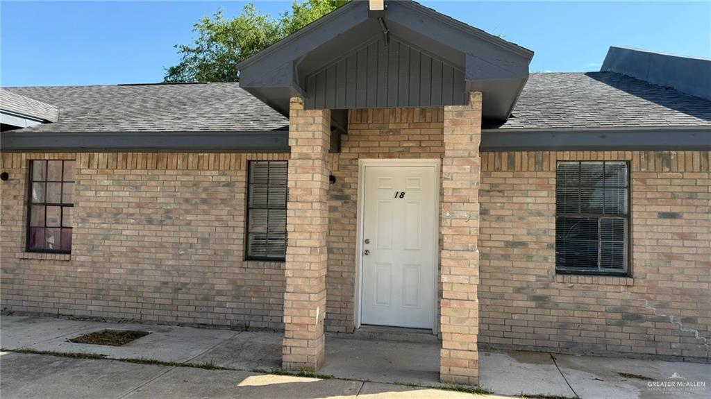 2714 West Mile 17 1/2 Road, Unit 18 Edinburg, TX 78541 - Photo 2 of 11 Doorway to property with brick siding and roof with shingles