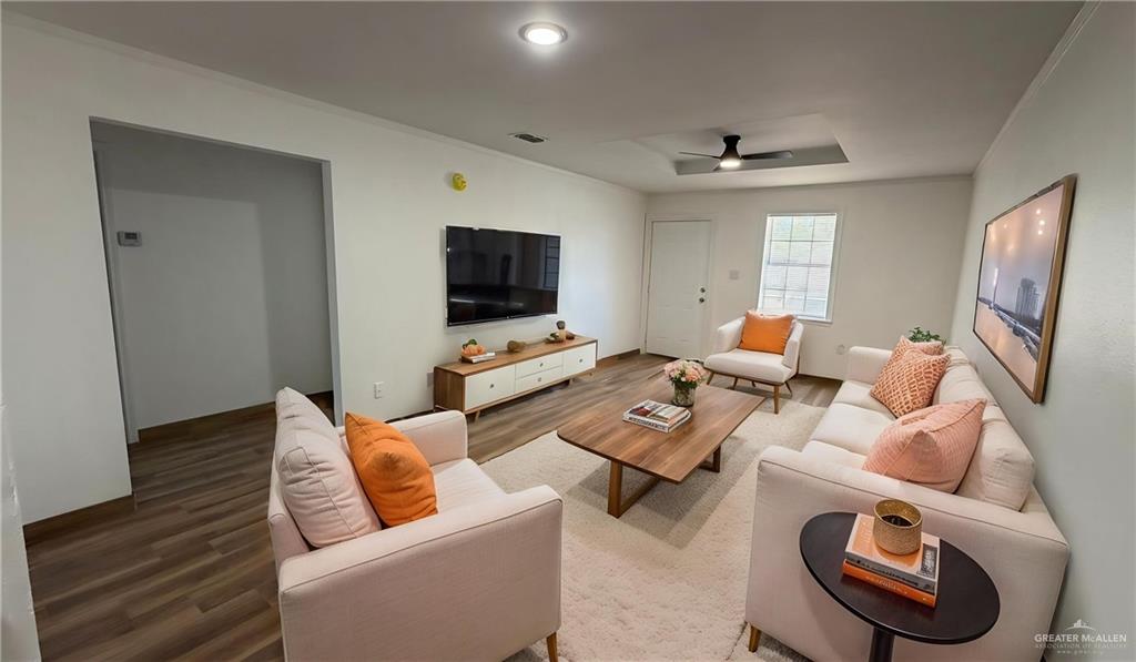2714 West Mile 17 1/2 Road, Unit 18 Edinburg, TX 78541 - Photo 3 of 11 Living room featuring wood finished floors, ornamental molding, and ceiling fan- property is virtually staged