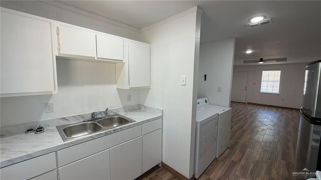 2714 West Mile 17 1/2 Road, Unit 18 Edinburg, TX 78541 - Photo 6 of 11 Laundry area with dark wood-type flooring, washing machine and clothes dryer, and recessed lighting