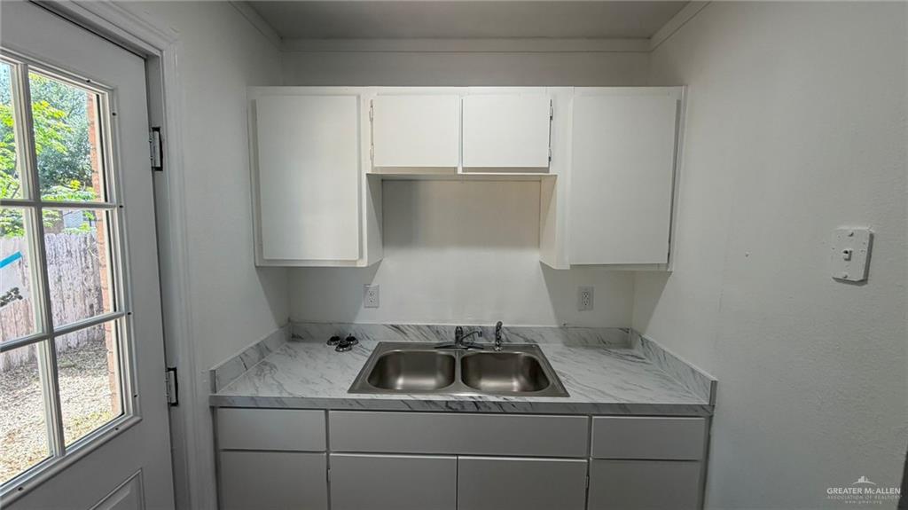 2714 West Mile 17 1/2 Road, Unit 18 Edinburg, TX 78541 - Photo 7 of 11 Kitchen with light countertops and white cabinets