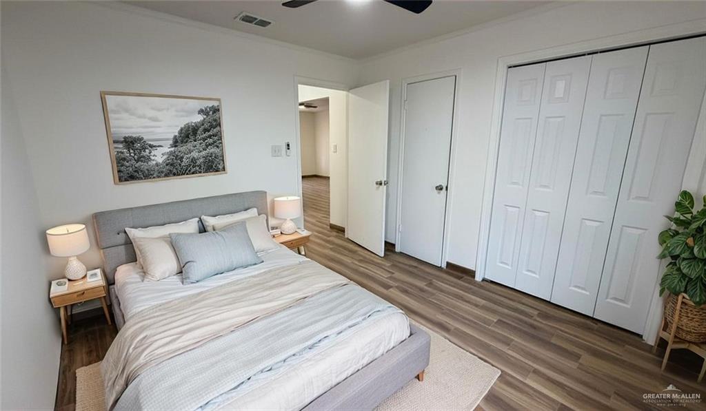 2714 West Mile 17 1/2 Road, Unit 18 Edinburg, TX 78541 - Photo 8 of 11 Bedroom with dark wood-style flooring, a closet, ceiling fan, and ornamental molding- property is virtually staged