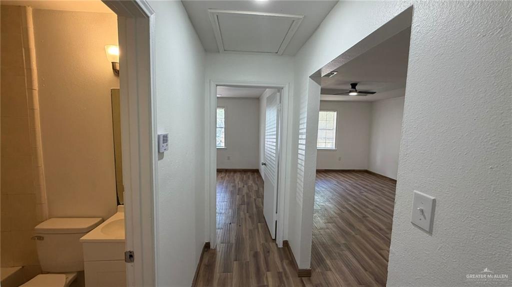 2714 West Mile 17 1/2 Road, Unit 18 Edinburg, TX 78541 - Photo 10 of 11 Corridor with dark wood-type flooring and a textured wall