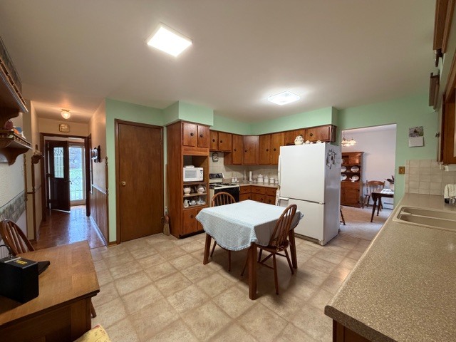 5563 Stone Drive Clinton, IL 61727 - Photo 12 of 34 a dining room with furniture and a refrigerator