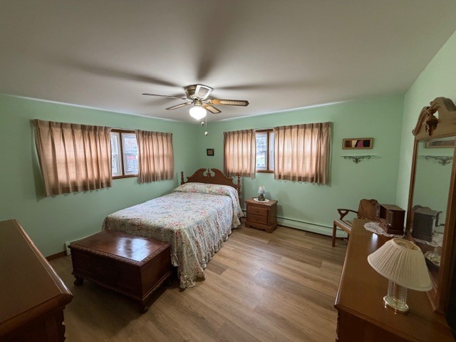 5563 Stone Drive Clinton, IL 61727 - Photo 18 of 34 a spacious bedroom with a bed and a chandelier