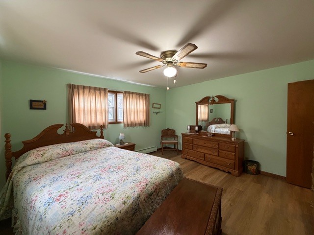 5563 Stone Drive Clinton, IL 61727 - Photo 20 of 34 a bed room with a bed and a chandelier