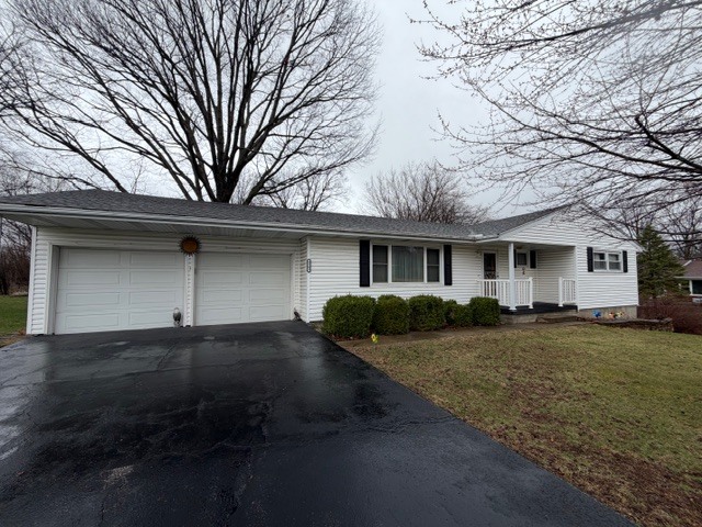 5563 Stone Drive Clinton, IL 61727 - Photo 2 of 34 a front view of a house with a yard and garage