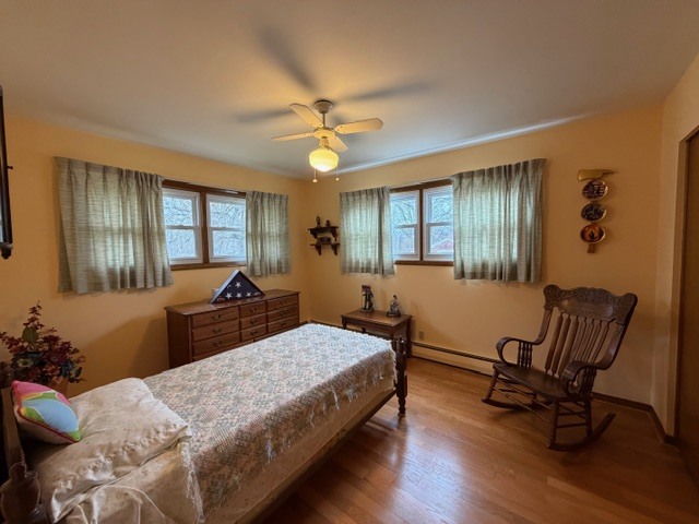 5563 Stone Drive Clinton, IL 61727 - Photo 21 of 34 a bedroom with a bed and a chandelier