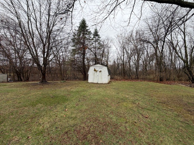 5563 Stone Drive Clinton, IL 61727 - Photo 29 of 34 a backyard of a house with trees and outdoor seating
