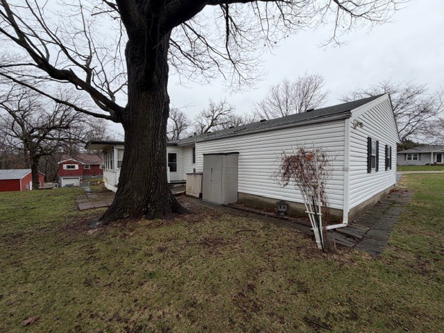 5563 Stone Drive Clinton, IL 61727 - Photo 33 of 34 a view of backyard with a large tree