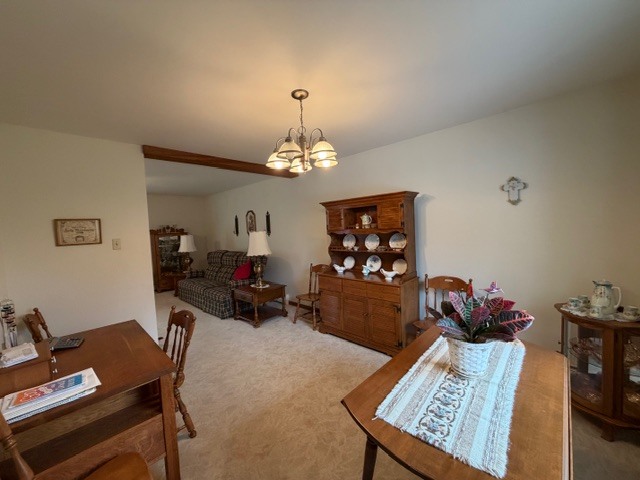 5563 Stone Drive Clinton, IL 61727 - Photo 8 of 34 a living room with furniture and a chandelier