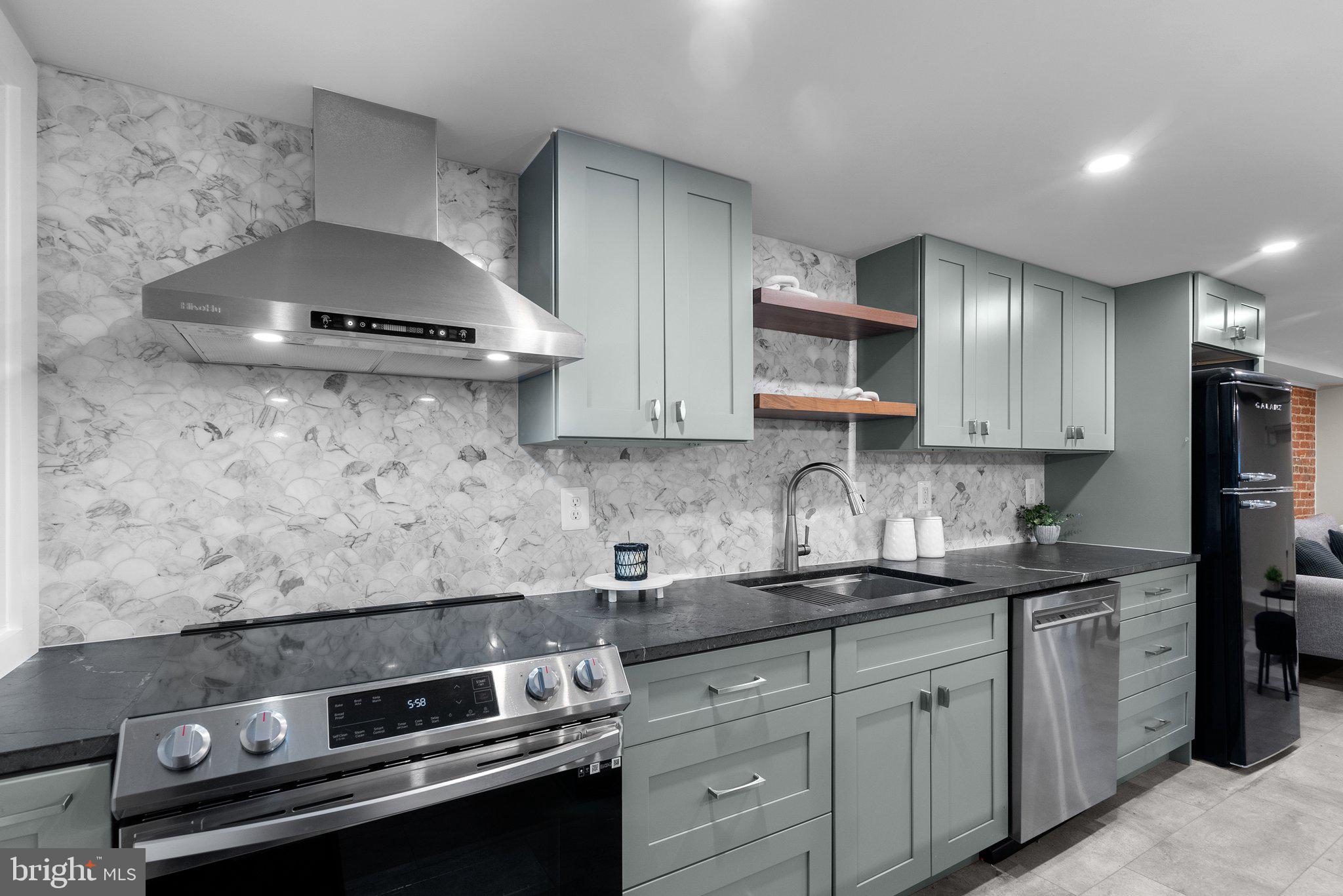 1616 Kilbourne Place Northwest Washington, DC 20010 - Photo 2 of 18 a kitchen with stainless steel appliances a stove and a sink