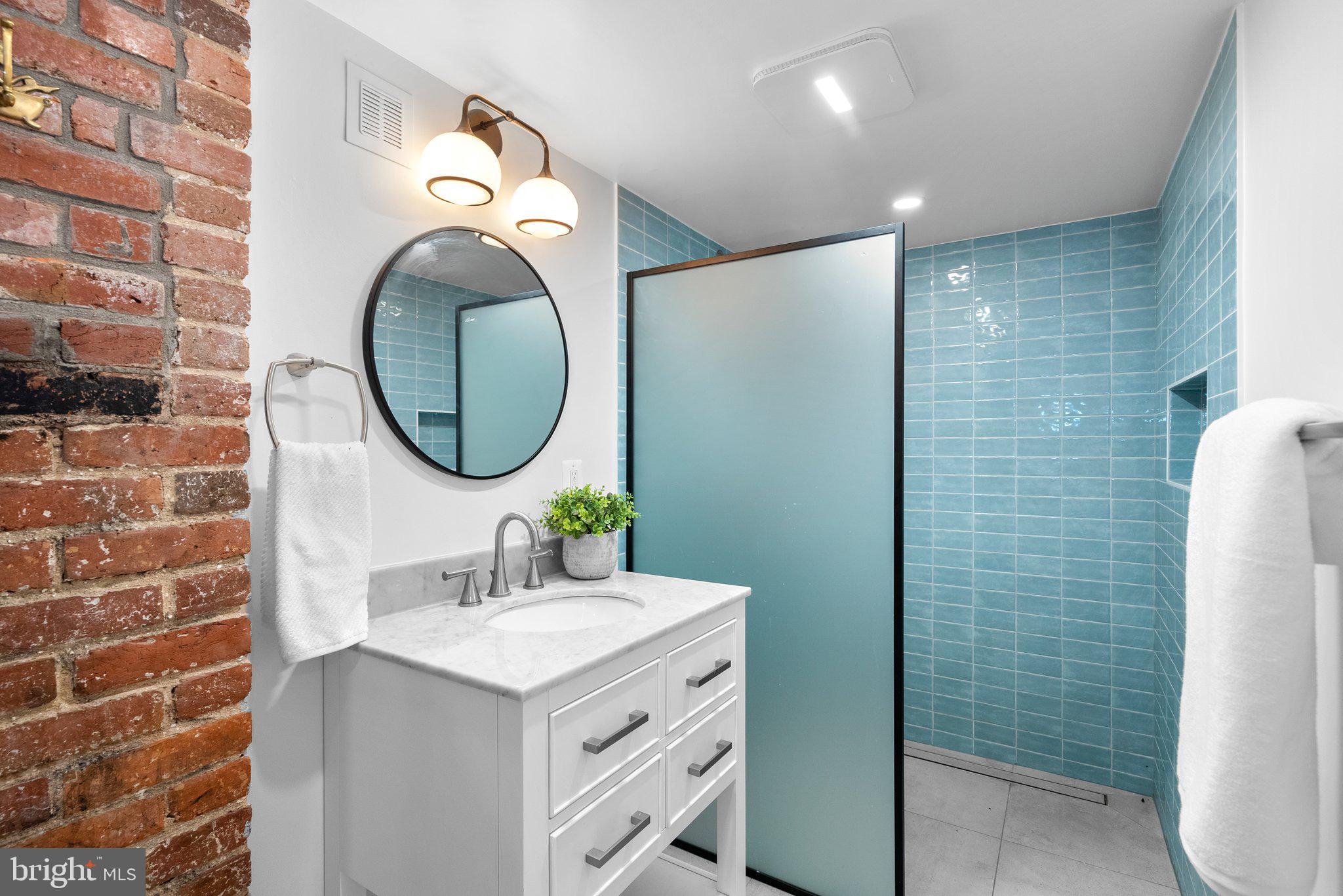 1616 Kilbourne Place Northwest Washington, DC 20010 - Photo 3 of 18 a bathroom with a sink and a mirror