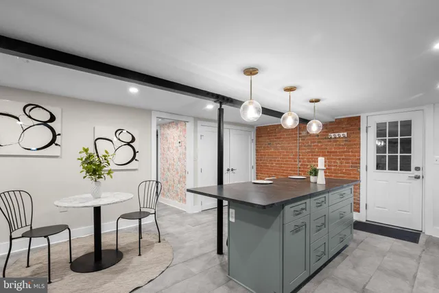 a kitchen with stainless steel appliances kitchen island granite countertop a stove and a sink