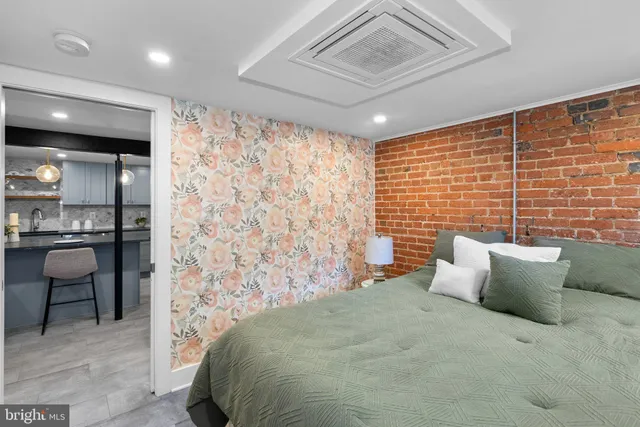 a bed sitting in a bedroom next to a blue wall