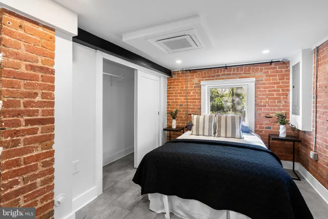 a view of residential houses with cars parked on the roadside