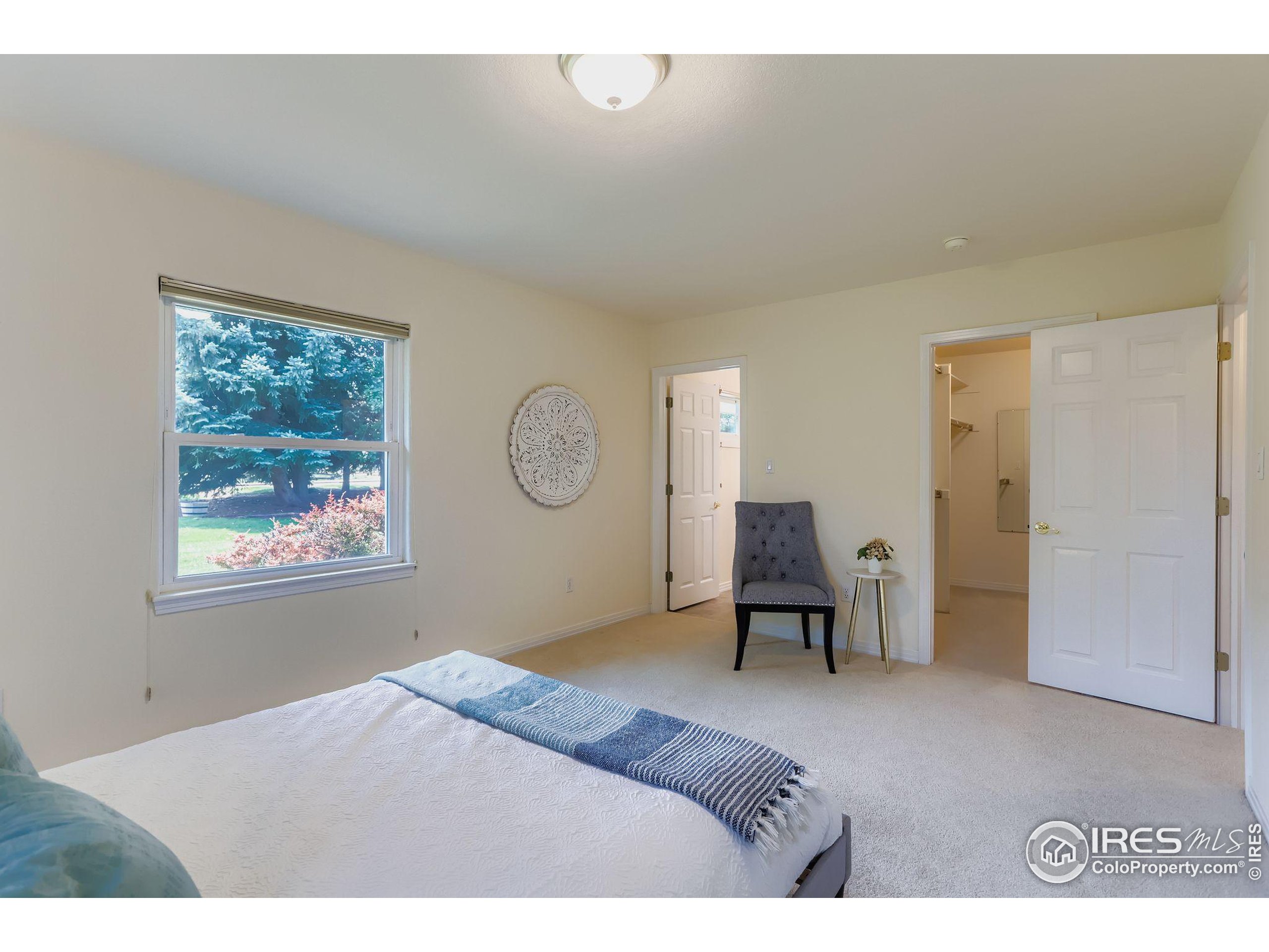 3600 Quail Road Longmont, CO 80503 - Photo 32 of 39 a bedroom with a bed and a window
