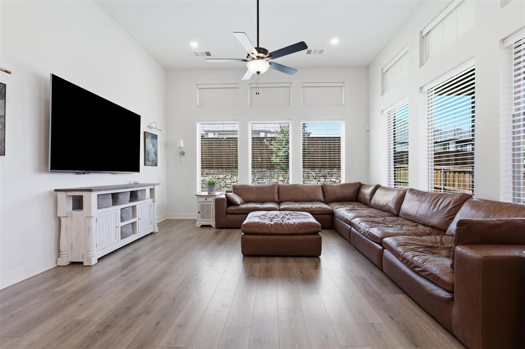 15413 Short Rdg Lane Fort Worth, TX 76008 - Photo 16 of 39 Spacious living area featuring high ceilings, wood-finish flooring, and ample natural light from multiple windows