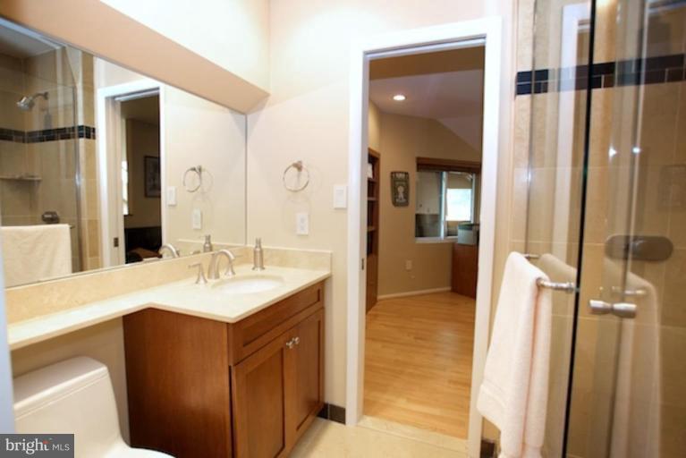 11601 Brandon Hill Way Reston, VA 20194 - Photo 16 of 27 a en suite bathroom with a sink a mirror and a shower