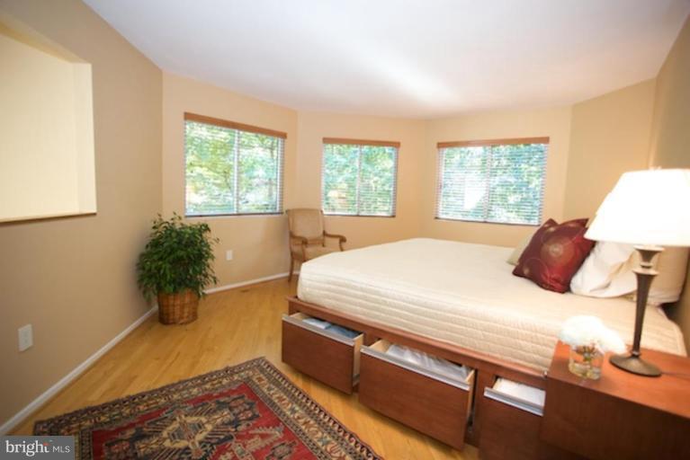 11601 Brandon Hill Way Reston, VA 20194 - Photo 20 of 27 a bed sitting in a bedroom next to a window