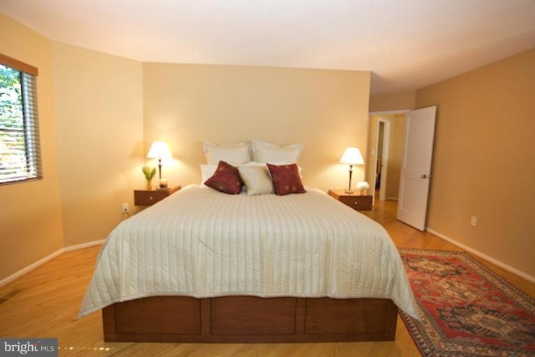11601 Brandon Hill Way Reston, VA 20194 - Photo 21 of 27 a bedroom with a bed and wooden floor