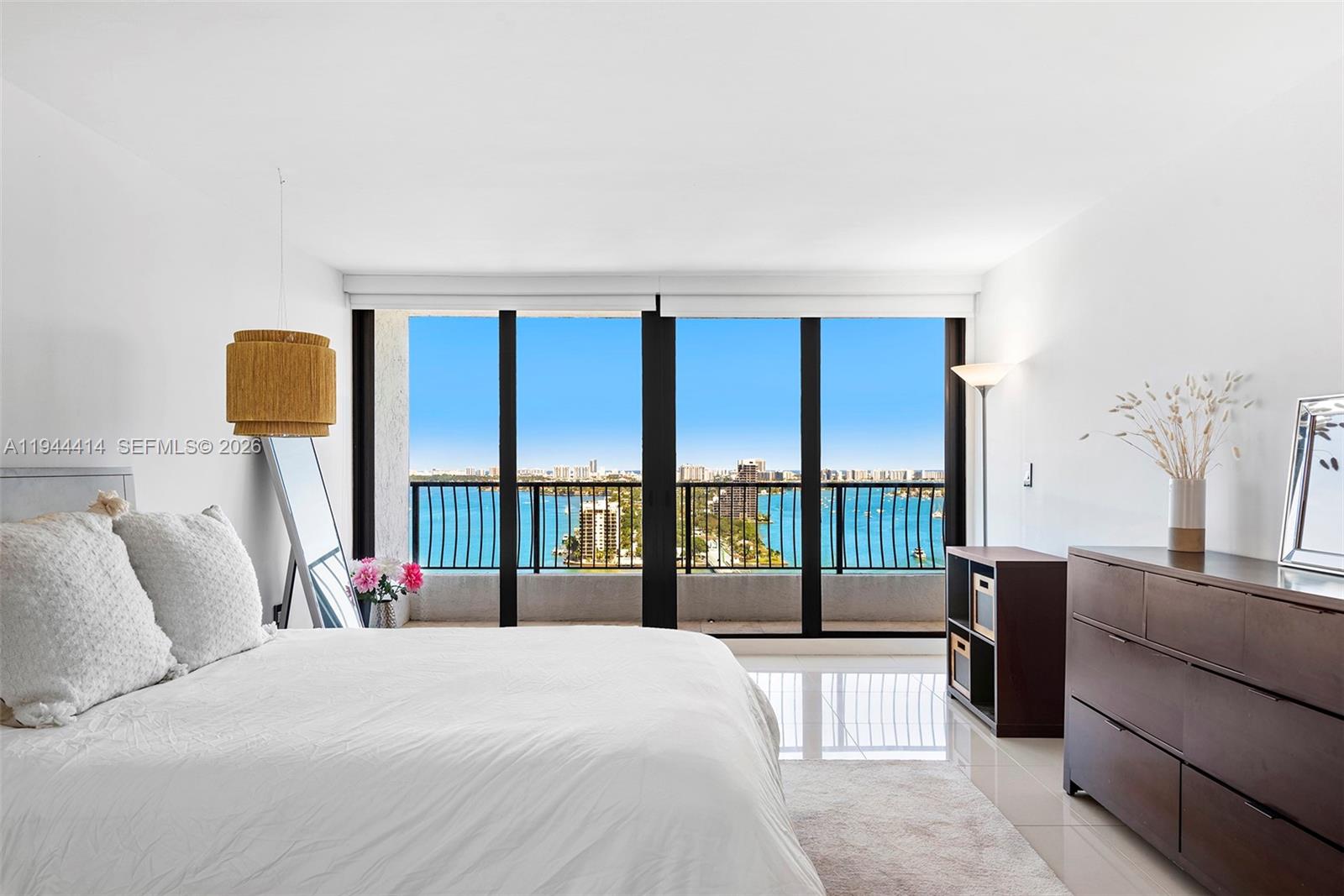 555 Northeast 15th Street, Unit 26B Miami, FL 33132 - Photo 11 of 18 a bedroom with a large bed and a balcony view