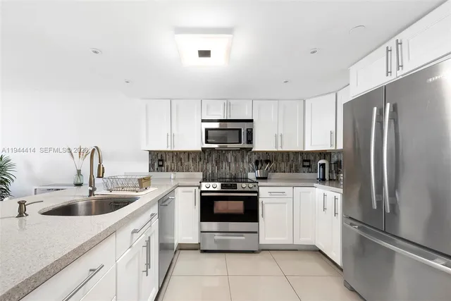 a kitchen with a sink stove and refrigerator
