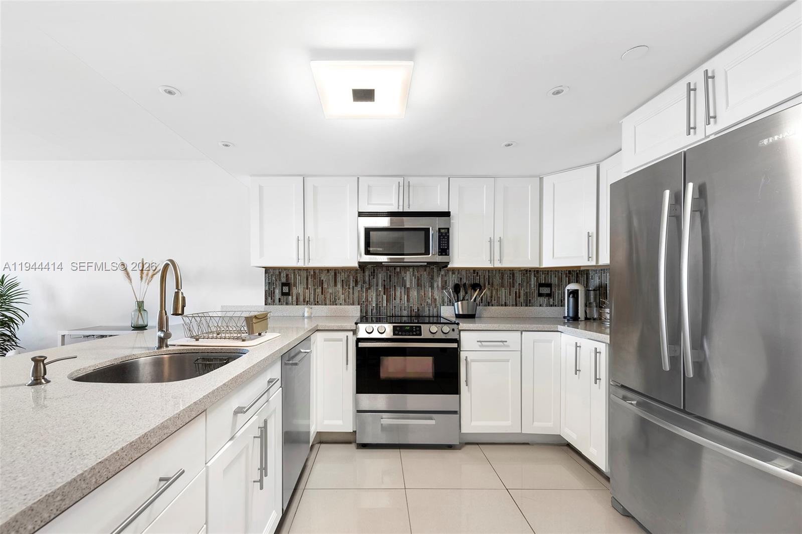 555 Northeast 15th Street, Unit 26B Miami, FL 33132 - Photo 8 of 18 a kitchen with a sink stove and refrigerator