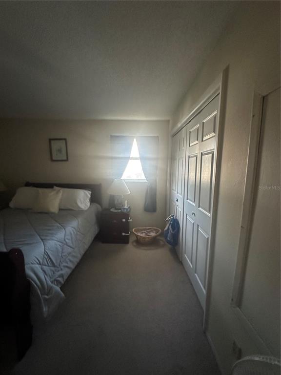 8440 Old Post Road, Unit 202 Port Richey, FL 34668 - Photo 7 of 17 a bedroom with a bed and a lamp