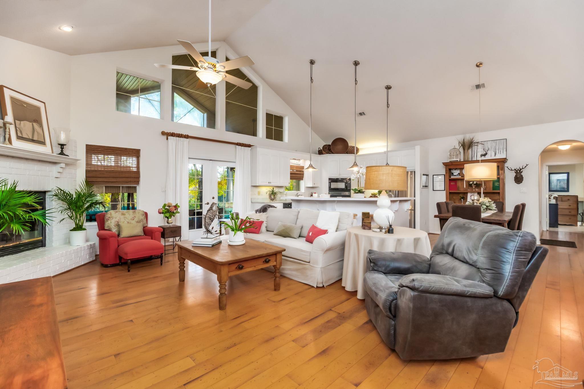 5150-5172 Siripon Road Milton, FL 32570 - Photo 12 of 54 a living room with furniture kitchen view and a wooden floor