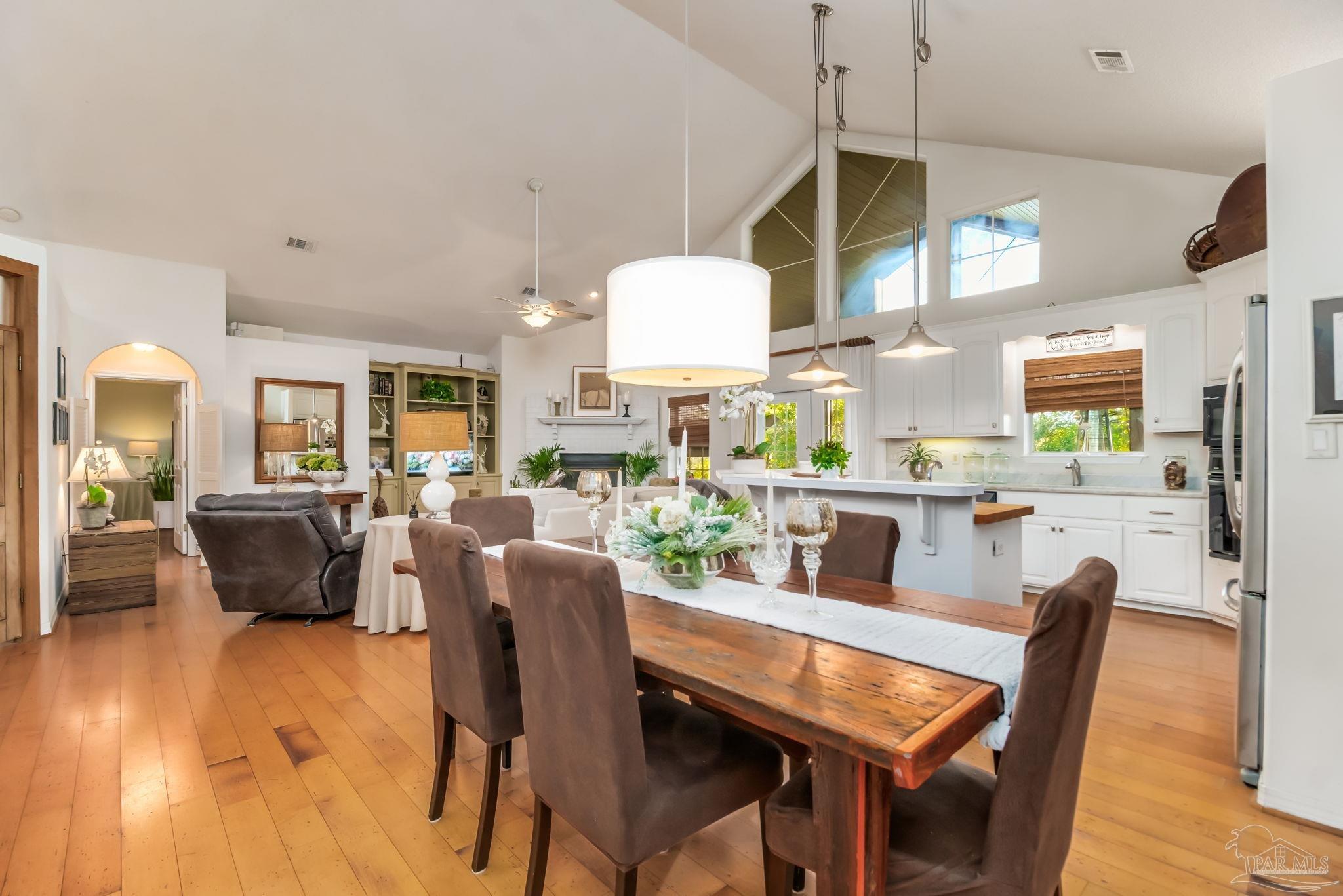 5150-5172 Siripon Road Milton, FL 32570 - Photo 13 of 54 a view of a dining room with furniture window and wooden floor