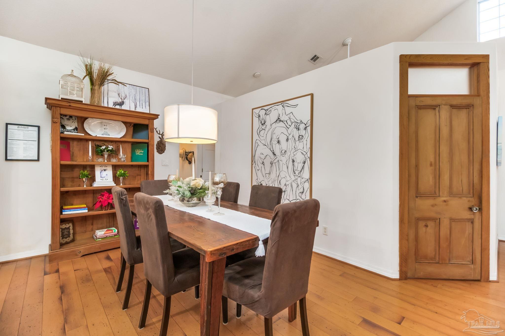 5150-5172 Siripon Road Milton, FL 32570 - Photo 15 of 54 a view of a dining room with furniture and wooden floor