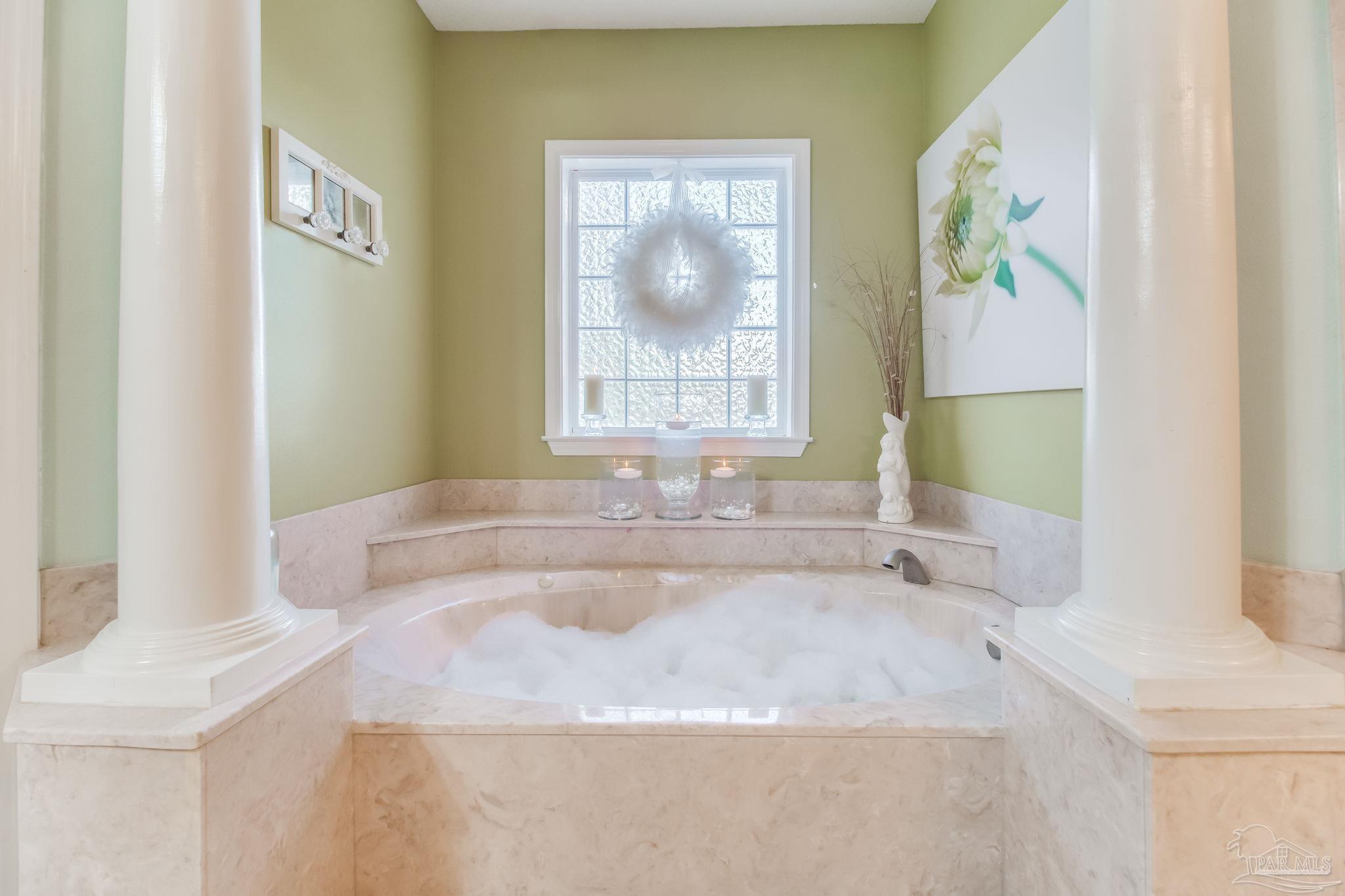 5150-5172 Siripon Road Milton, FL 32570 - Photo 17 of 54 a bathroom with a granite countertop sink a mirror a window and a bathtub