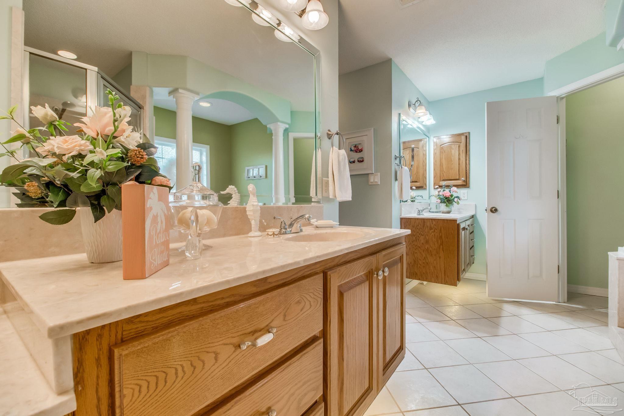 5150-5172 Siripon Road Milton, FL 32570 - Photo 18 of 54 a bathroom with a granite countertop sink a large mirror and a shower